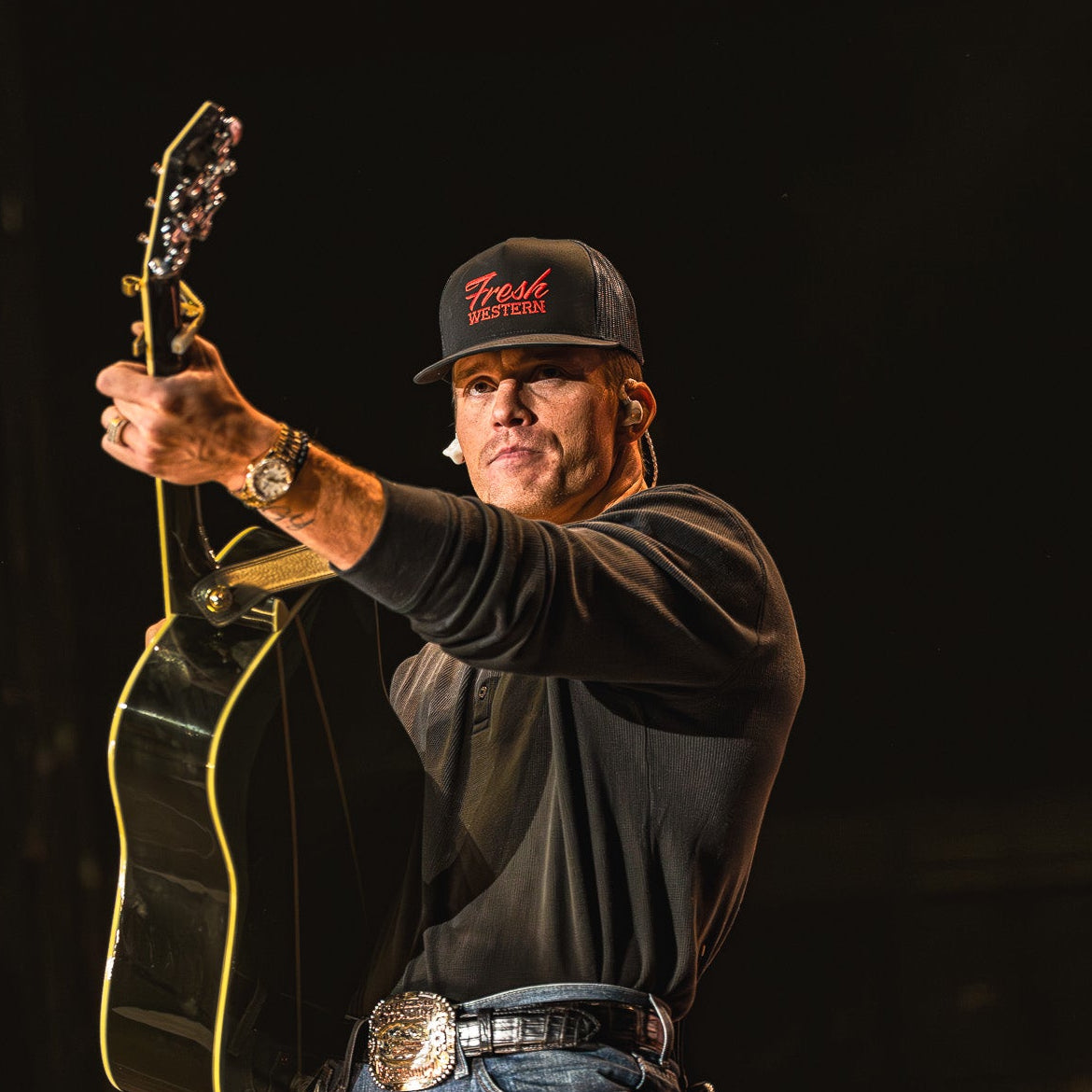 Parker McCollum wearing Black + Red Fresh Western Tour Hat on stage
