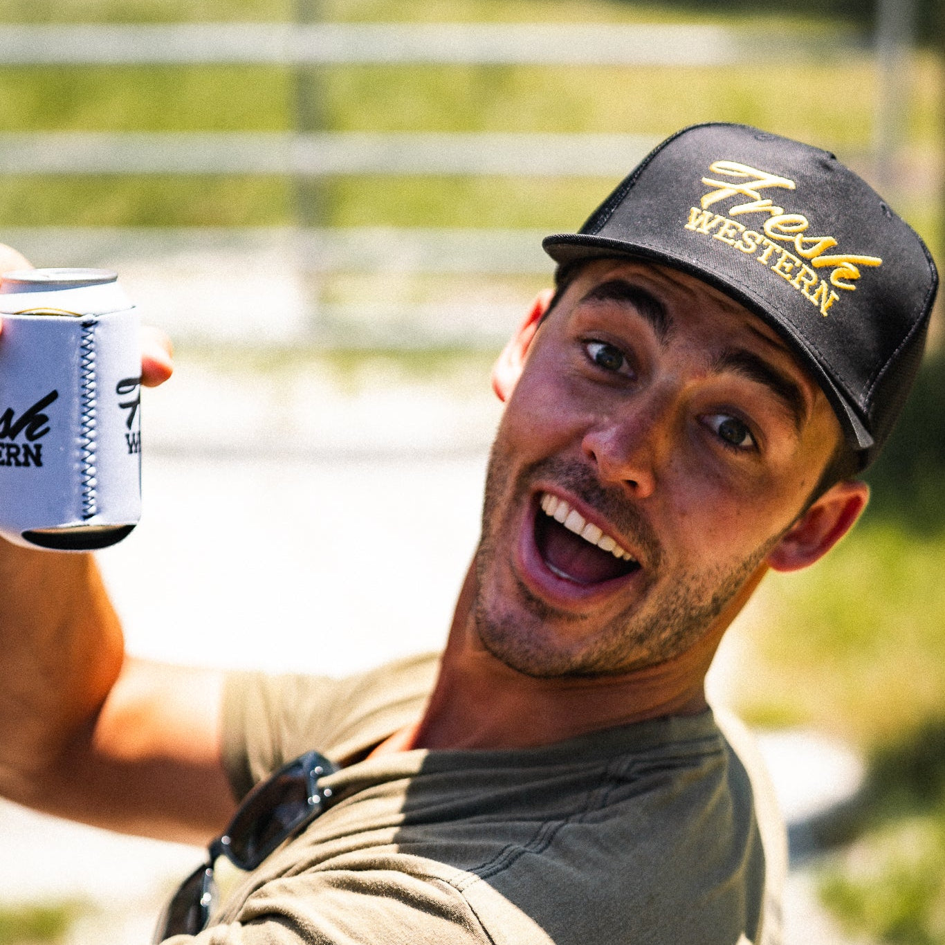 Man holding a can wearing a Black 5-Panel Truck Hat with Gold Fresh Western Embroidery Logo