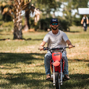 Man riding dirt bike wearing a Navy 5-Panel Truck Hat with White Fresh Western Embroidery Logo